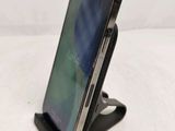 a cell phone that is on a stand on a table