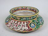 a small vase with a decorative design on it