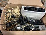 a cardboard box filled with electronic devices and wires