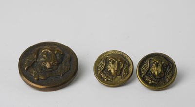 a pair of brass buttons with a picture of a man and a woman