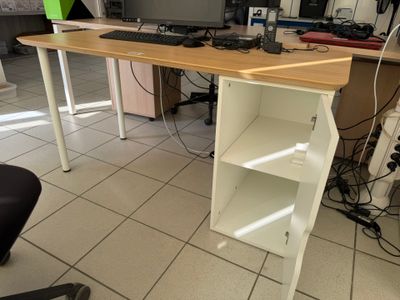 a desk with a computer on top of it in a room