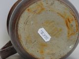 a close up of a brown cup with a tag on it