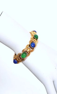 a close up of a bracelet on a mannequin hand