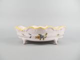 a white bowl with yellow trim and flowers on it