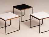 three black and white tables sitting on top of a white surface