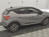 the rear end of a gray car parked in a garage