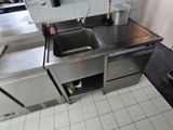 a kitchen with a sink and a refrigerator in it
