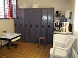 a room with a table, chairs, and lockers in it