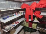 a room with a lot of shelves and a red bow on it