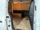 a white van with the door open and a bench in the back