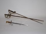 two different types of swords on display on a white surface