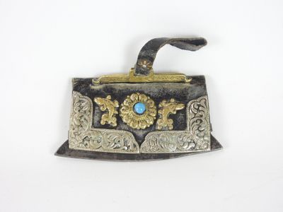 an antique silver and gold purse with a blue stone in the center