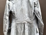 the back view of a gray jacket on a mannequin dummy