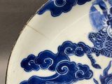 a blue and white plate with a dragon on it