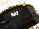 a purse that is sitting on a table with a name tag on it