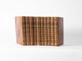 an image of a set of five books on a wooden block