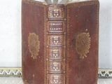 an old book sitting on top of a white table