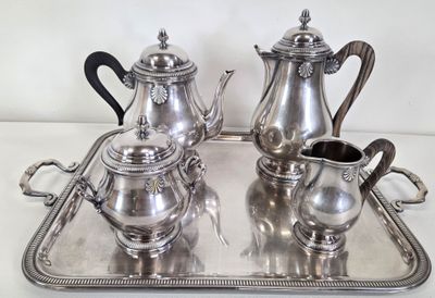 a silver tray with a silver tea set on it