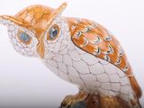 a figurine of an owl with a hat on it ' s head