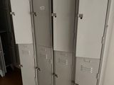 several metal lockers are lined up against a wall in a room