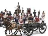 a lot of figurines of soldiers and a horse drawn carriage