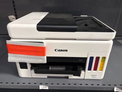 une imprimante Canon posée sur une étagère dans un magasin