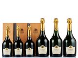 a group of six bottles of champagne in front of a wooden box