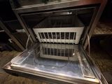an open oven with a basket inside of it