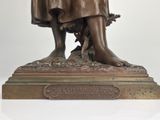 bronze statue of a woman with a dog on a pedestal