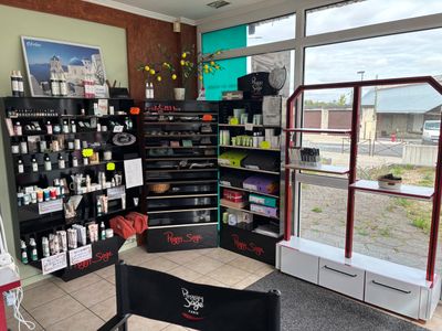 an image of a salon with a lot of products on the shelves