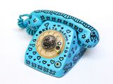 a blue phone with hearts on it sitting on a white surface