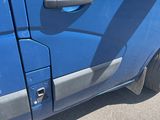 a small blue car with a broken door and a broken window