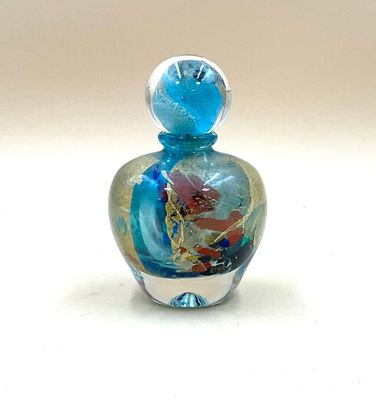 a small glass bottle with a colorful design on it