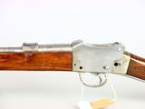 a close up of a gun on a white background with a tag