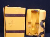 a yellow box with a wine glass and a bottle in it