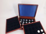 three wooden boxes with buttons in them on a white surface