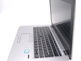 a silver laptop with a blue sticker on the screen
