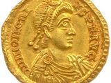 une pièce d'or à l'effigie d'un homme portant une coiffe