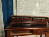 a wooden desk with a mirror on top of it