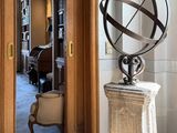 a sculpture of a sundial on a pedestal in a room