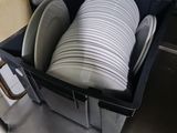 a black container filled with white plates and bowls