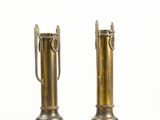 pair of brass vases with handles on each side of them