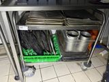 a kitchen cart with a bunch of pans on it