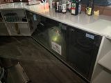 many bottles of alcohol sitting on the counter in this kitchen