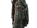 bronze statue of a man in armor holding a sword and shield