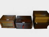 three small wooden boxes are lined up next to each other