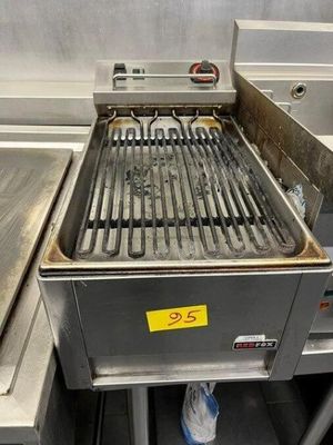 a grill that is sitting in the middle of a kitchen