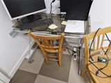a computer desk with two monitors and a laptop on it