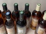 several bottles of wine are lined up on a table