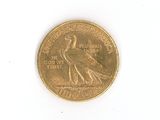 a gold coin with a bird on it on a white surface